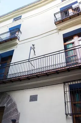 a white building with balconies and a fence at Welcomer Apartments Valencia in Valencia