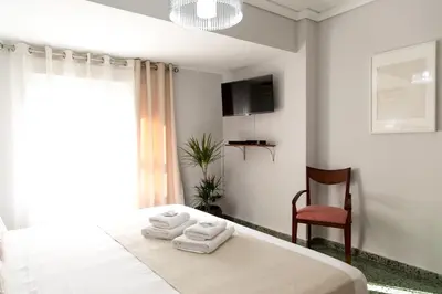 a bedroom with a bed with towels on it at MD Vila Barbera in Valencia