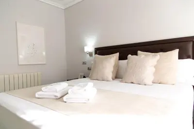 a bedroom with a bed with towels on it at MD Vila Barbera in Valencia
