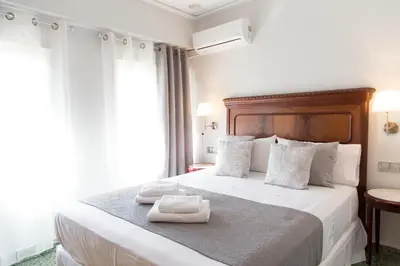 a hotel room with a bed with two towels on it at MD Vila Barbera in Valencia