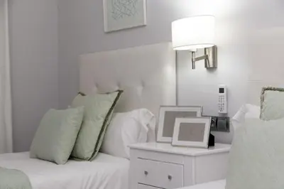 a white room with a couch and a table with a picture at MD Vila Barbera in Valencia
