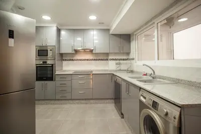 a kitchen with white cabinets and a sink at MD Vila Barbera in Valencia