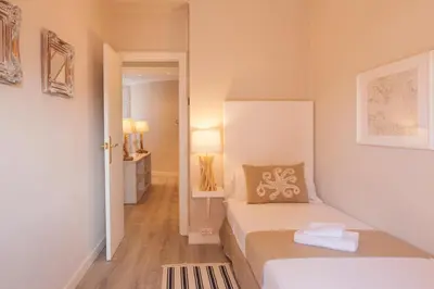 a small room with a bed and a hallway at MD Benlliure Cabañal Beach in Valencia