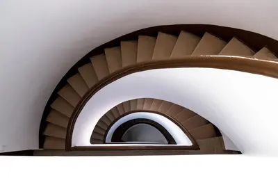 a spiral staircase in a building with a round window at MD Benlliure Cabañal Beach in Valencia