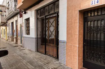 a building with black doors on the side of a street at MD Benlliure Cabañal Beach in Valencia