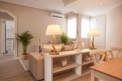 a living room with a couch and a table at MD Benlliure Cabañal Beach in Valencia