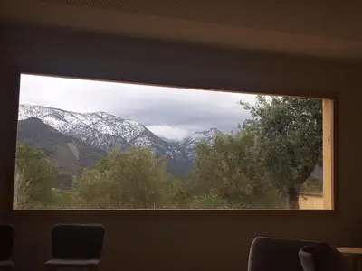 a window with a view of a snow covered mountain at Mar de Fulles in Alfondeguilla
