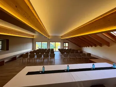 an empty lecture hall with chairs and a table at Mar de Fulles in Alfondeguilla