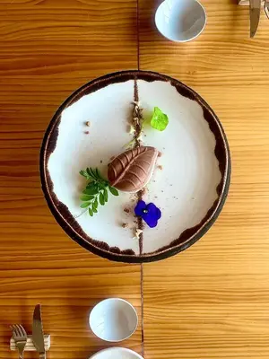 a plate of food on a wooden table at Mar de Fulles in Alfondeguilla