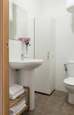 a white bathroom with a sink and a toilet at Victoria Site-Mercat Central in Valencia