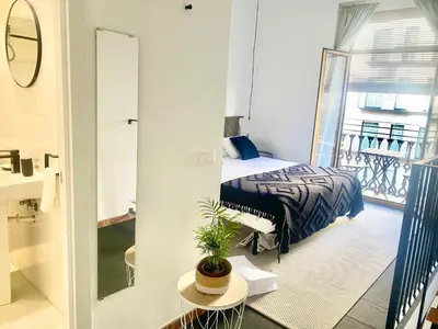 a bedroom with a bed and a balcony at Victoria Site-Mercat Central in Valencia