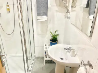 a white bathroom with a sink and a shower at Victoria Site-Mercat Central in Valencia