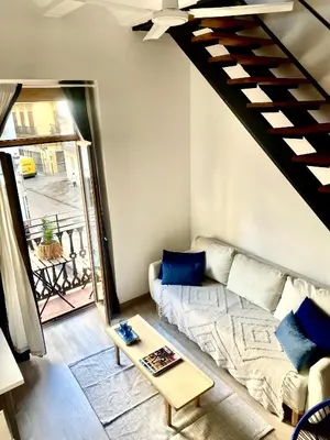 a living room with a couch and a staircase at Victoria Site-Mercat Central in Valencia