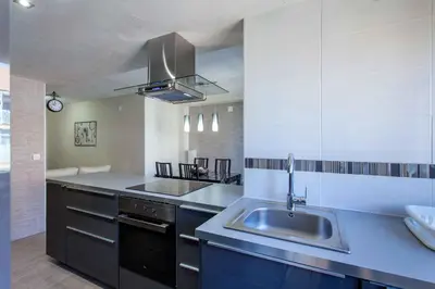 a large kitchen with a sink and a stove at Apartment Malvarrosa Beach Cavite in Valencia