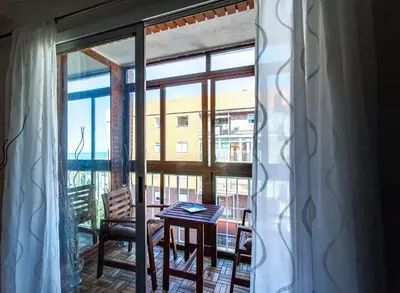 a balcony with a table and chairs and a window at Apartment Malvarrosa Beach Cavite in Valencia