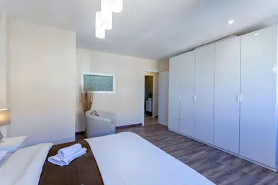 a bedroom with a large bed with white cabinets at Apartment Malvarrosa Beach Cavite in Valencia