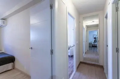a bedroom with white walls and a walk in closet at Apartment Malvarrosa Beach Cavite in Valencia