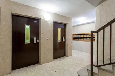 two black doors in a hallway with a staircase at Apartment Malvarrosa Beach Cavite in Valencia