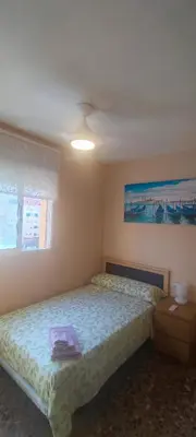 a bedroom with a bed with a purple towel on it at Pasarela Apartment in Valencia