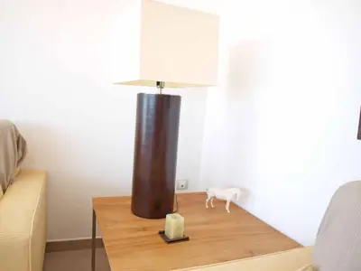 a table with a lamp and a candle on it at ApartUP Patacona Panoramic in Valencia