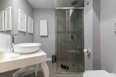 a white bathroom with a shower and a sink at MD Pelayo in Valencia