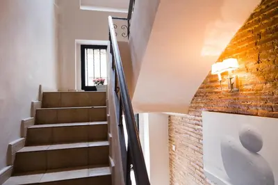 a staircase in a house with a brick wall at MD Pelayo in Valencia