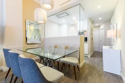 a dining room with a glass table and chairs at MD Pelayo in Valencia