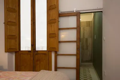 a bedroom with wooden doors and a closet at Eco-Friendly Apartments in Valencia