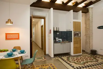 a kitchen and dining room with a table and chairs at Eco-Friendly Apartments in Valencia