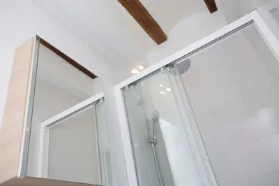 a glass shower in a bathroom with white walls at Blanquerias Apartments in Valencia