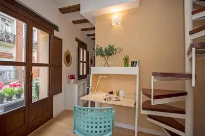 a room with a table and a chair and a window at Blanquerias Apartments in Valencia