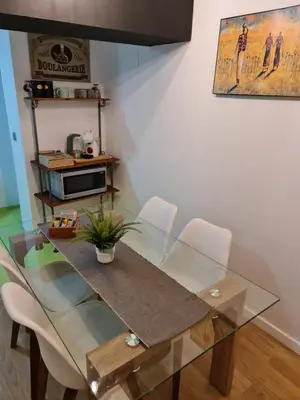 a dining room with a glass table and chairs at Apartamentos El Olivo in Valencia