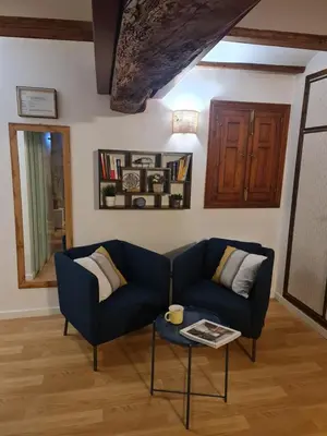 a living room with a blue couch and a table at Apartamentos El Olivo in Valencia
