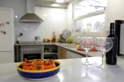 a bowl of food on a counter with two wine glasses at El Campillo, casa de campo cerca de la playa in Navajas