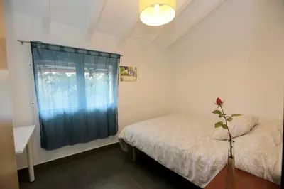 a small bedroom with a bed and a window at El Campillo, casa de campo cerca de la playa in Navajas