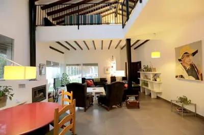a large living room with a table and chairs at El Campillo, casa de campo cerca de la playa in Navajas