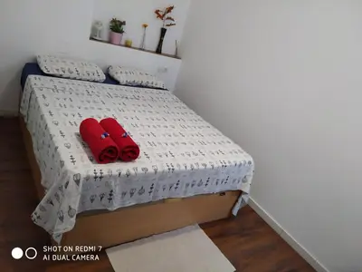 a bed with two red pillows on it at Apartment on Carrer del Dr. Lluch in Valencia