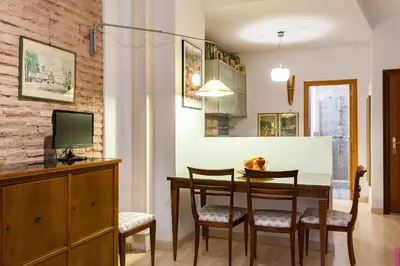a dining room with a table and chairs and a tv at My Loft 4 You Borgia in Valencia