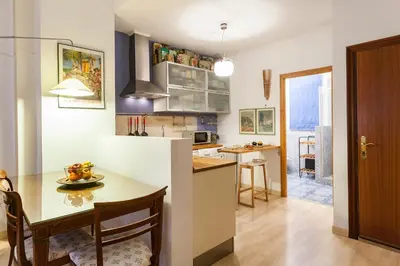 a kitchen with a table and a dining room at My Loft 4 You Borgia in Valencia