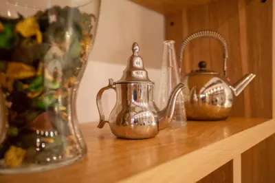 two tea pots and a pitcher on a wooden shelf at Apartamento Horno in Valencia