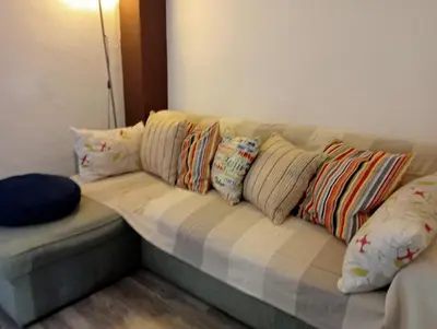 a couch with pillows on it in a room at Lola Apartment Encorts in Valencia