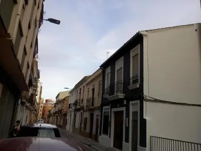 a car parked on a city street with buildings at Lola Apartment Encorts in Valencia