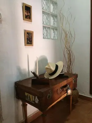 a hat sitting on top of an old suitcase at La casita Santa Bárbara in Macastre