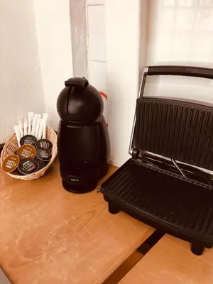 a coffee maker sitting on a table next to a basket of coffee at La casita Santa Bárbara in Macastre