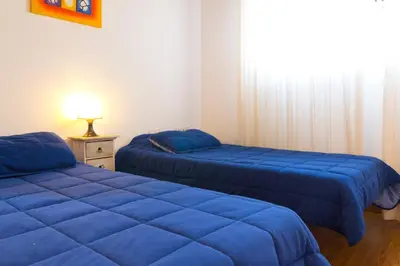 two beds in a room with blue sheets at My Penthouse Valencia in Valencia
