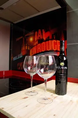 two wine glasses sitting on a table with a bottle of wine at My Penthouse Valencia in Valencia