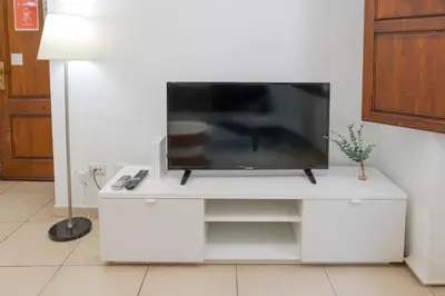 a tv sitting on a white entertainment center at Quart Silence in Valencia