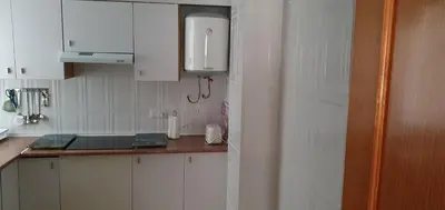 a kitchen with white cabinets and a counter top at Apartamento Ciudad de las Ciencias in Valencia