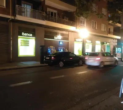 two cars parked on the side of a street at night at Apartamento Ciudad de las Ciencias in Valencia