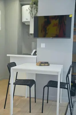 a white table and two chairs in a kitchen at La Casa Verde - Ruzafa in Valencia